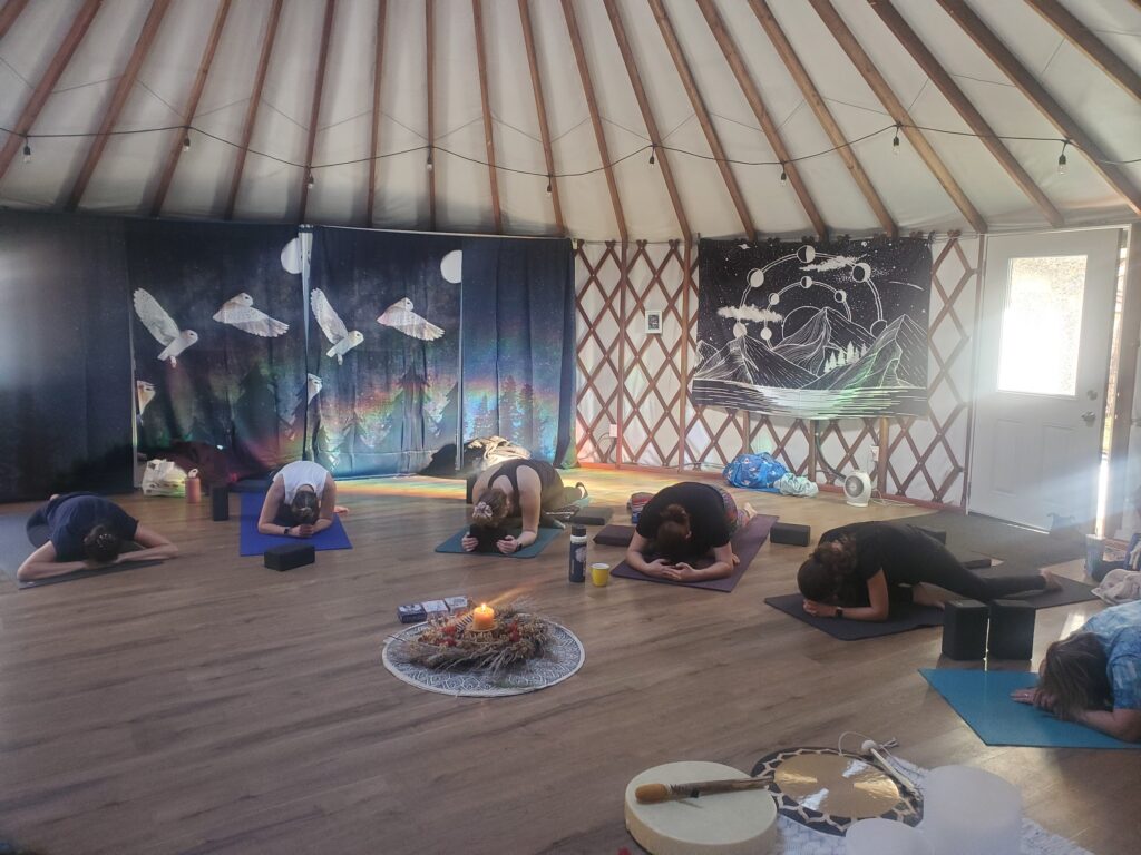 people in the yurt doing yoga